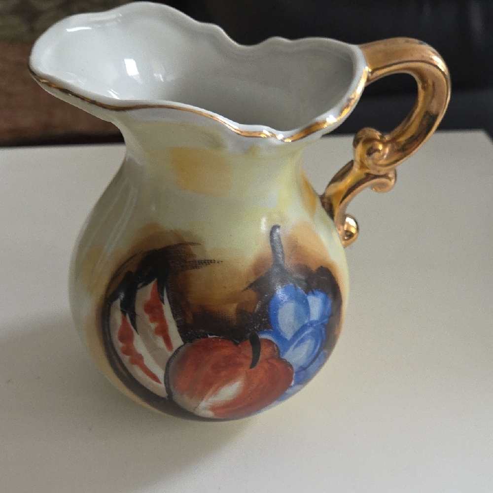 Elegant Gold-Trimmed Ceramic Pitcher with Colorful Design